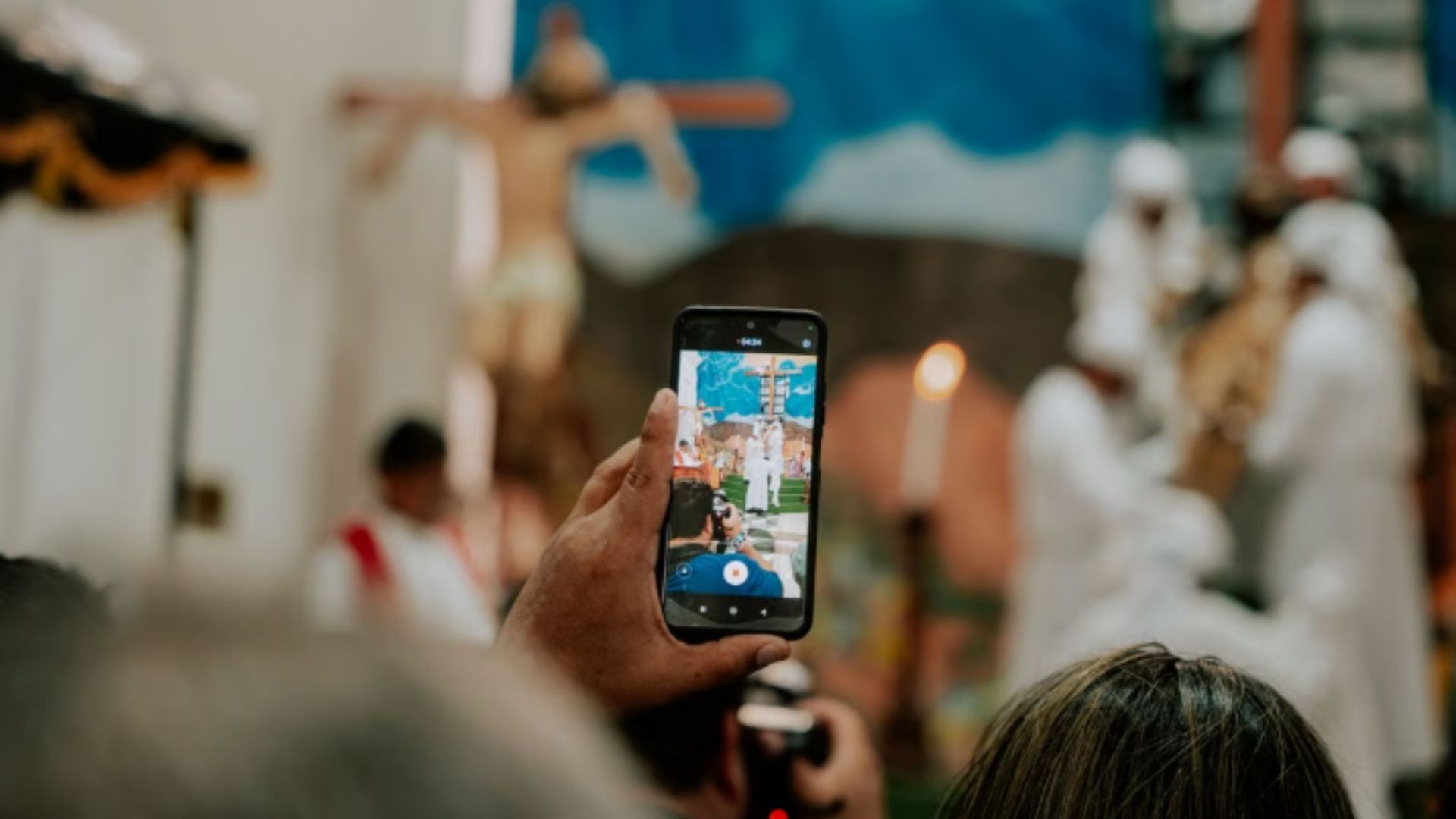 Church attendee following a multilingual service on a smartphone in a worship sanctuary
